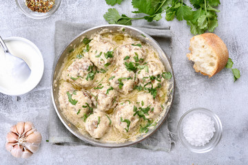 Dinner with meatballs in white sauce