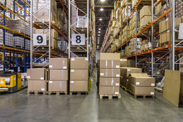 Interior of warehouse with racks full of boxes and goods © a_medvedkov
