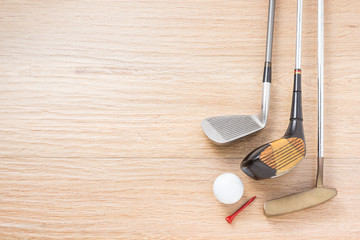 golf club, ball and red tee on space of wood floor