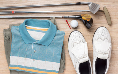 stilll life photography : golf club, clothes and shoes on wood floor background, golfer concept