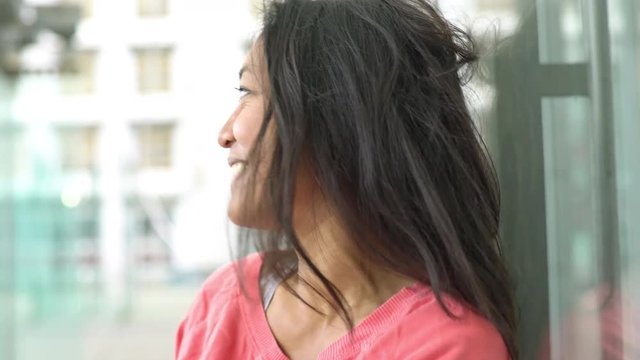 Woman laughing outdoors, portrait
