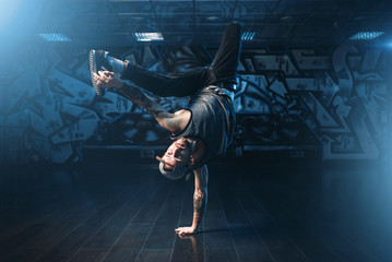 Breakdance action, dancer posing in dance studio