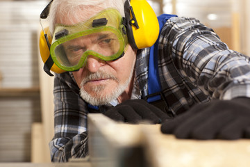 Carpenter working in furniture factory