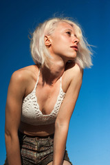 Naklejka premium Caucasian girl sunbathing on the sky background
