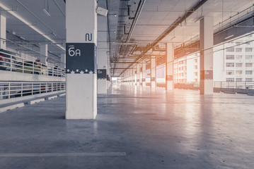 interior of parking garage with car and vacant parking lot