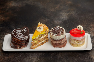 Arrangement of cake and candies on long white plate