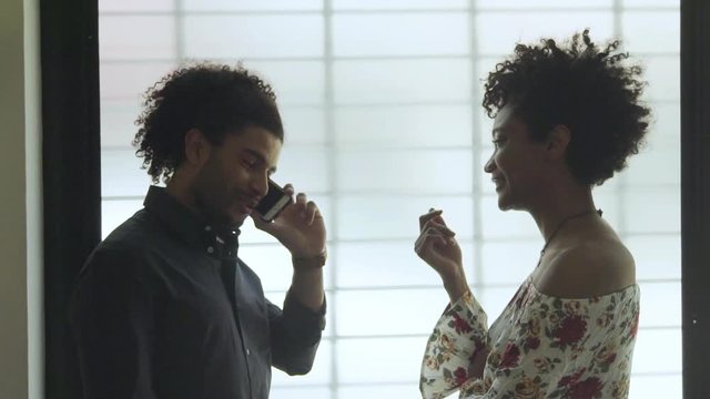 Man chatting on phone while companion waits