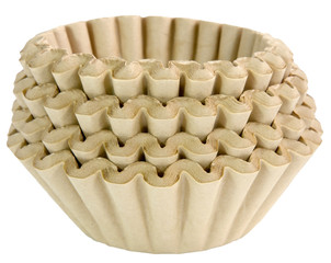 Stacked unbleached brown basket coffee filters. Isolated.