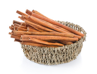 Cinnamon in basket on white background