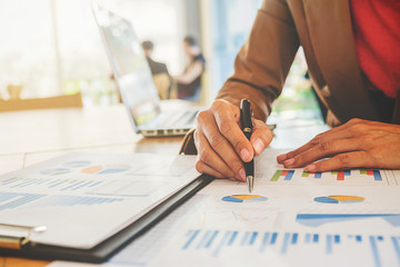 Business concept. Business people discussing the charts and graphs showing the results of their successful teamwork.