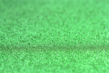 Fototapeta premium Shiny green glitter paper defocused texture background.