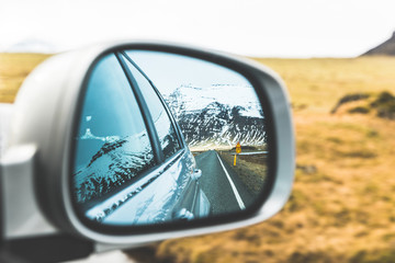 Snow and mountains view on wing mirror