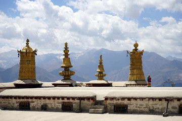Fototapeta na wymiar Golden stupas on the roof