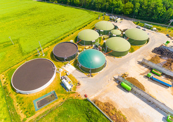 Aerial view over biogas plant and farm in green fields. Renewable energy from biomass. Modern agriculture in Czech Republic and European Union. 