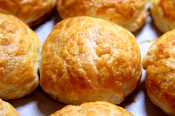Baked sweet buns on a baking sheet with a ruddy crust, homemade delicious cakes