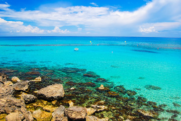 Fototapeta na wymiar Rocks and sea bay with azure water near Protaras, Cyprus island