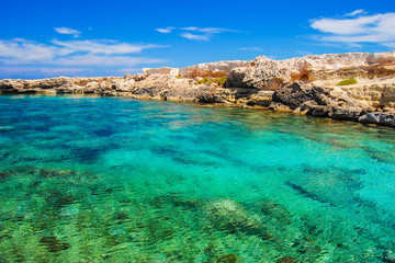 Fototapeta na wymiar Rock cliffs and sea bay with azure water near Protaras, Cyprus island