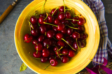 Sweet cherries on rustic wooden background
