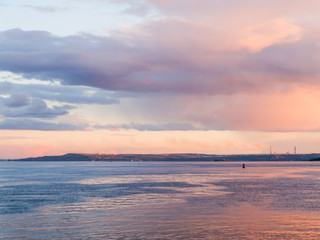 Scenic evening river landscape. Blue and pink sky at sunset. Russia, Saratov city, the Volga river.