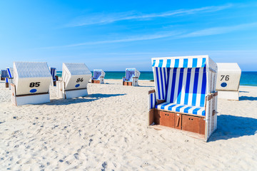 Wicker chairs on white sand Kampen beach, Sylt island, North Sea, Germany