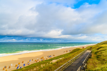 Coastal walkway along Wenningstedt beach at sunrise, Sylt island, North Sea, Germany