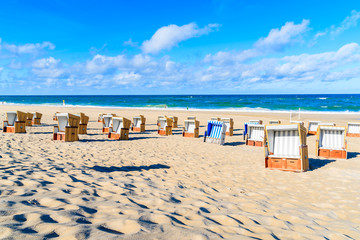 Wicker chairs on white sand beach in Wenningstedt village on Sylt island, North Sea, Germany