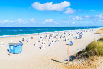 Wicker chairs on sandy beach in Kampen village on Sylt island, North Sea, Germany
