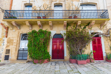 Senglea, Malta - Traditional red doors and houses on the streets of Senglea