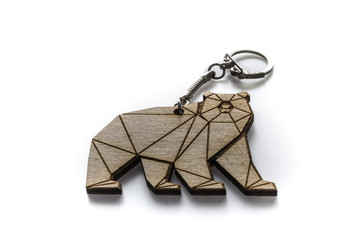 Wooden kodiak bear keychain closeup on white background