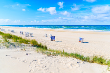 View of sand dune and wicker chairs on beach in Kampen village, Sylt island, North Sea, Germany