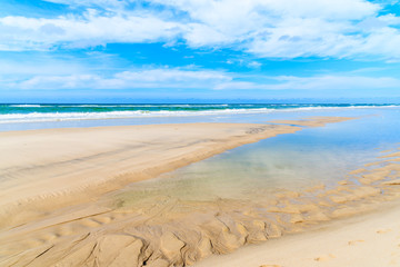 Shallow crystal clear sea water at Kampen beach at low tide, Sylt island, North Sea, Germany