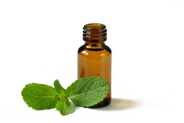 Mint essential oil in glass bottle isolated on white background.