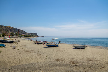 Fototapeta na wymiar Boats in a Mediterranean beach of Ionian Sea - Bova Marina, Calabria, Italy