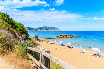 Fototapeta premium View of sandy Es Figueral beach with sunbeds and umbrellas, Ibiza island, Spain