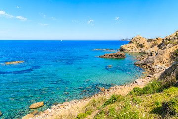 Blue sea water on coast of Ibiza island in Es Figueral bay, Spain