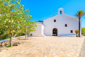 Square with white typical church in Sant Vicent de sa Cala village in northern part of of Ibiza island, Spain © pkazmierczak