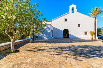 Square with white typical church in Sant Vicent de sa Cala village in northern part of of Ibiza island, Spain © pkazmierczak