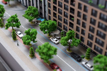 Miniature model, miniature toy buildings, cars and people. City maquette.