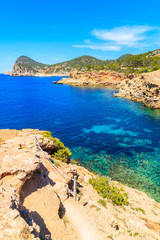 Fototapeta na wymiar Blue sea water of Punta Galera bay surrounded by amazing stone formations, Ibiza island, Spain