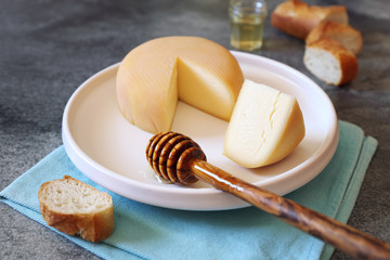 French cheese, baguette and honey on  wooden table