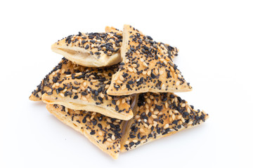 Crisps with nuts and seeds stacked on a white background.