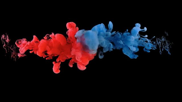 Real shot color paint drops in water in slow motion. Ink swirling underwater. Cloud of ink collision isolated on black background with alpha. Colorful abstract smoke explosion animation. Close up view