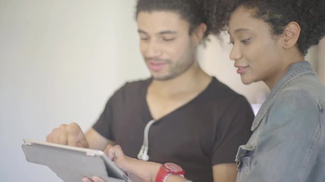 Couple using digital tablet together