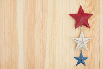 Red, white and blue stars on wood background