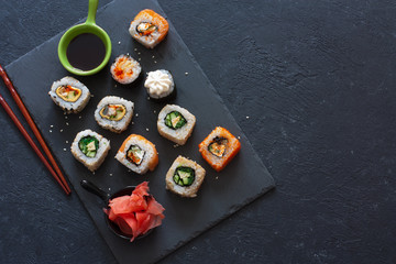 Set of  sushi rolls served on stone slate