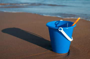 a child's bucket on the beach