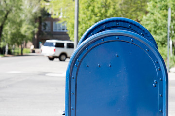 Profile of two blue roadside mailboxes