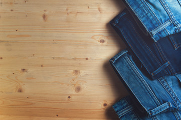Blue denim jeans on wooden table.