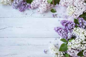 A wooden background with flowering lilac branches