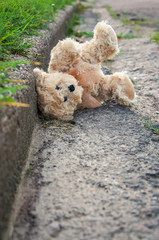a teddy bear on the side of the road